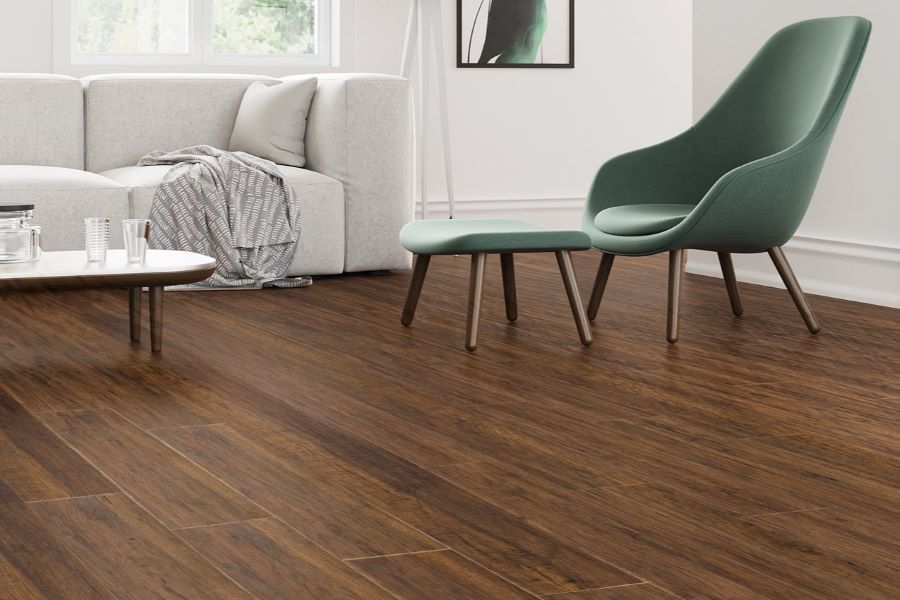 Green chairs and dining table on light brown laminate floor